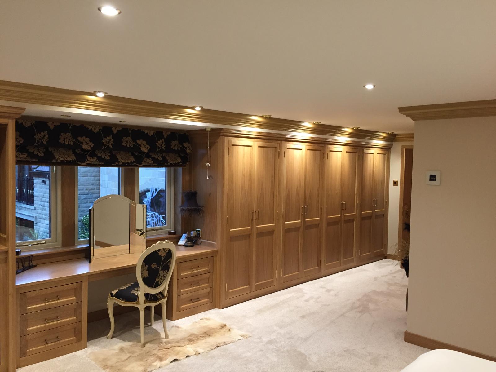Misura Joinery fitted wardrobes and furniture — bespoke oak bedroom storage with dressing table