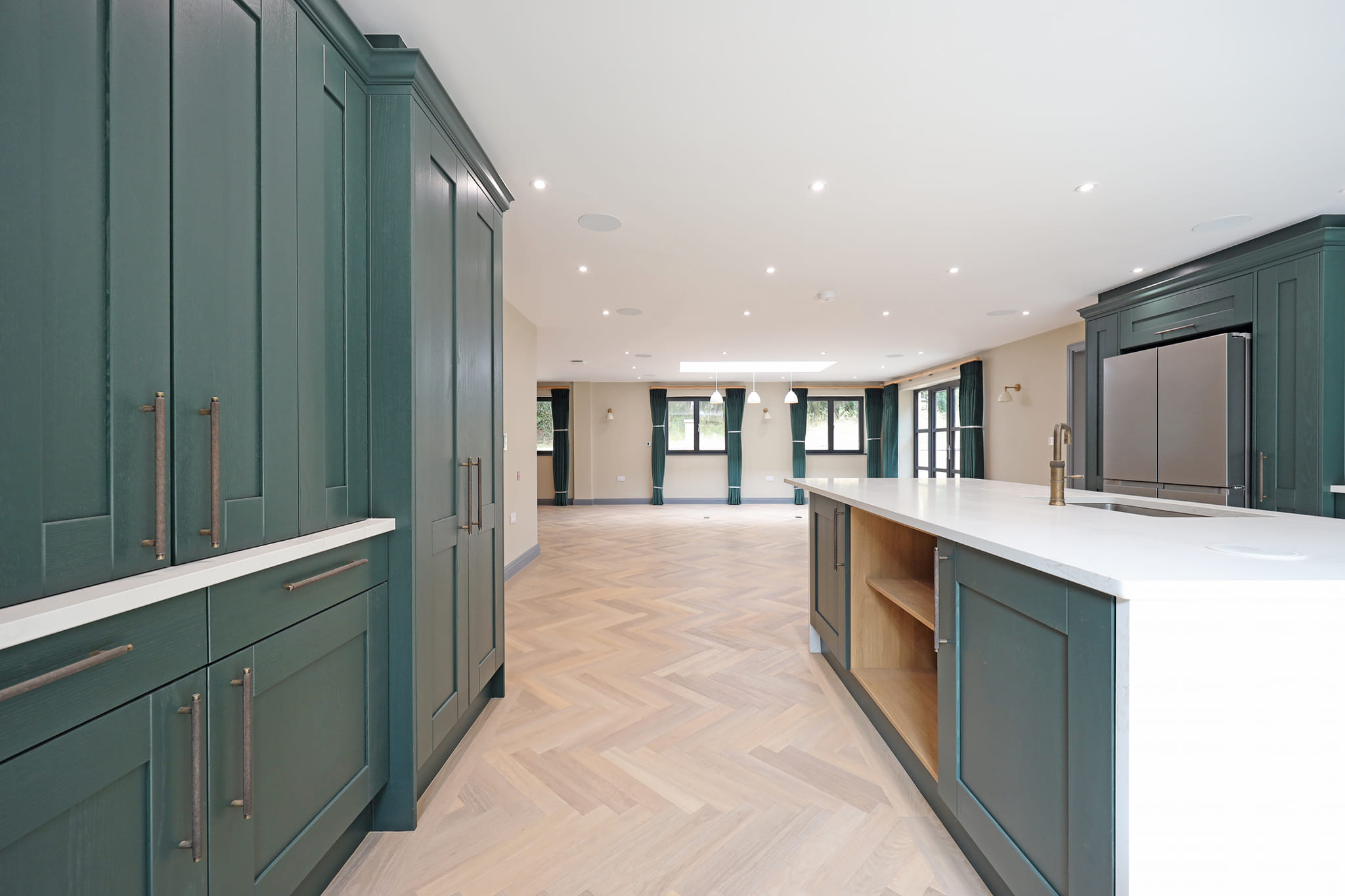 Misura Joinery bespoke green shaker kitchen — open plan kitchen installation by Misura